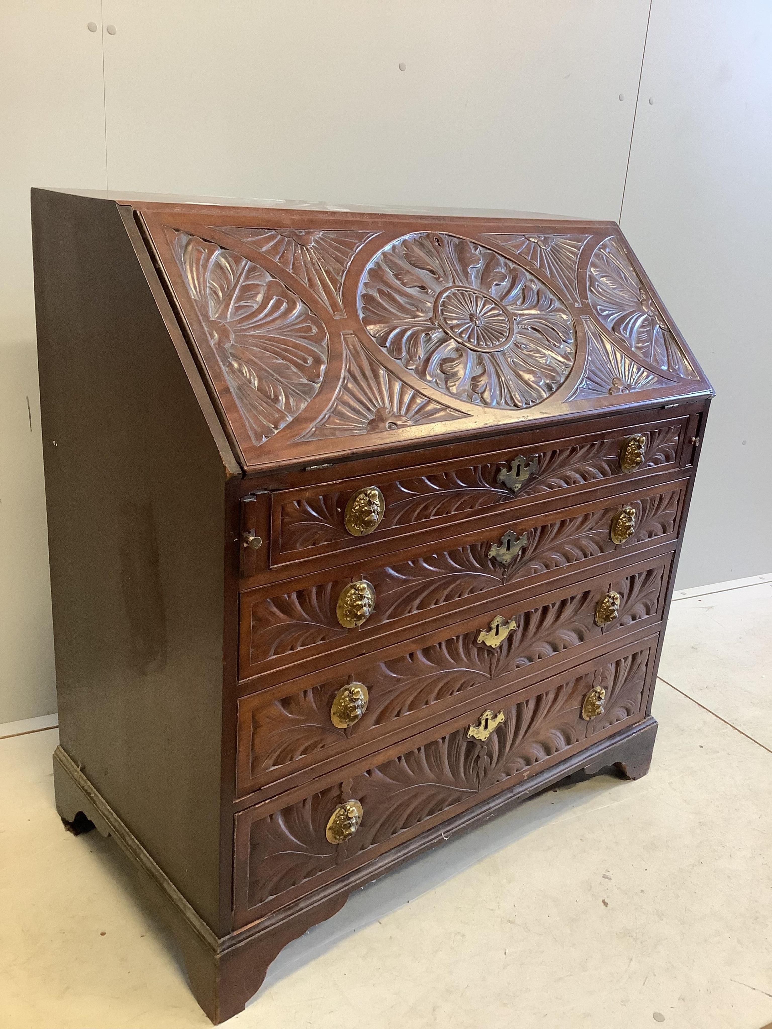 A George III later carved mahogany bureau, width 99cm, depth 56cm, height 106cm. Condition - fair